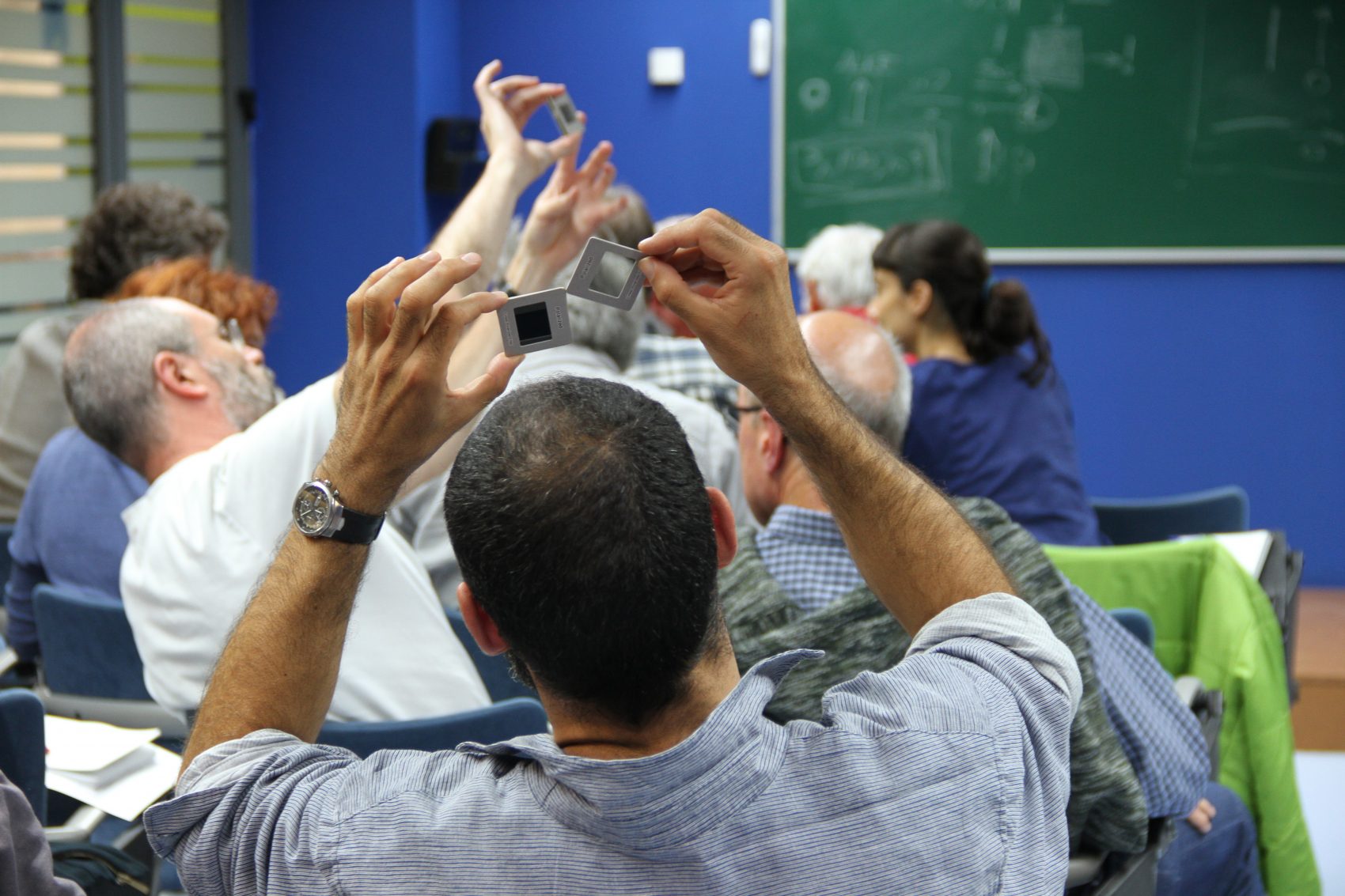 teachers in a classroom learning how to use a polarizer