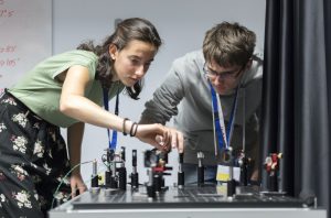 High school students working on an optical setup during BIYSC