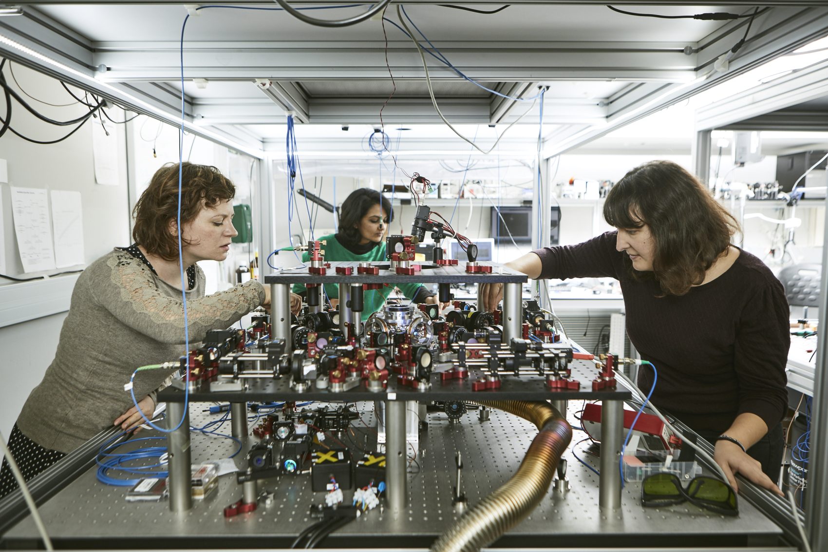 three women working in a photonics lab